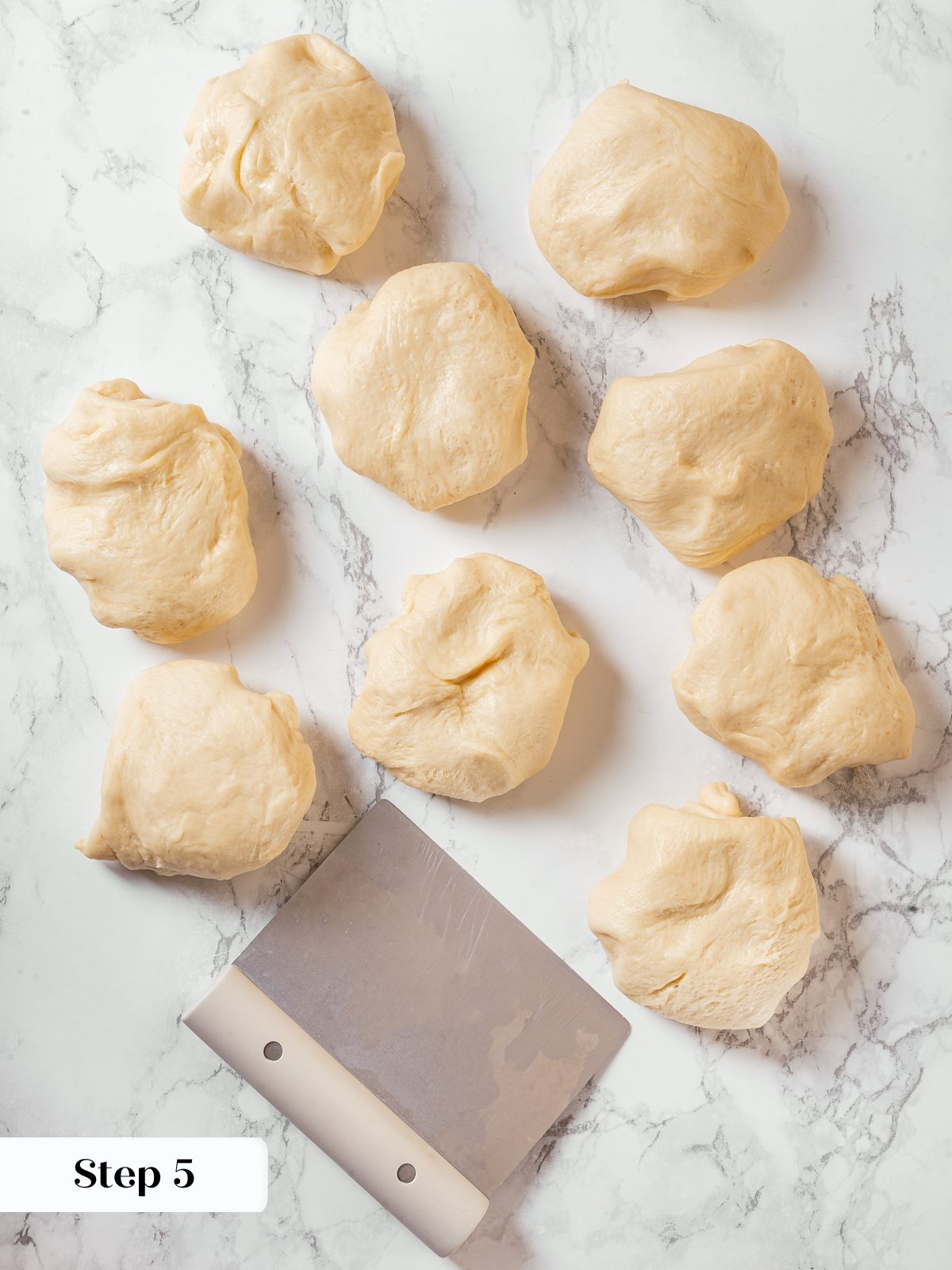 Milk bread dough divided into equal portions before shaping rolls.