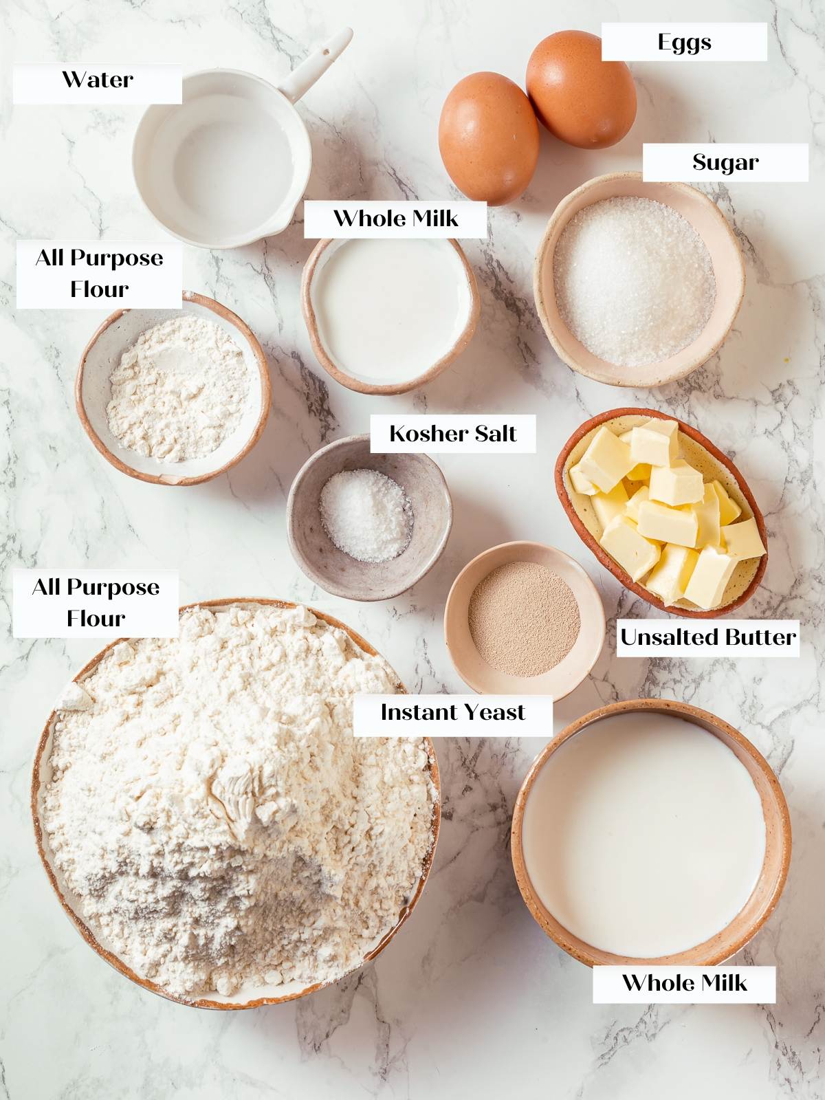 Ingredients for milk bread arranged on countertop including flour milk butter egg and yeast.