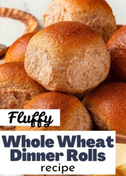 Golden brown whole wheat dinner rolls with butter. Text overlay reads fluffy texture.