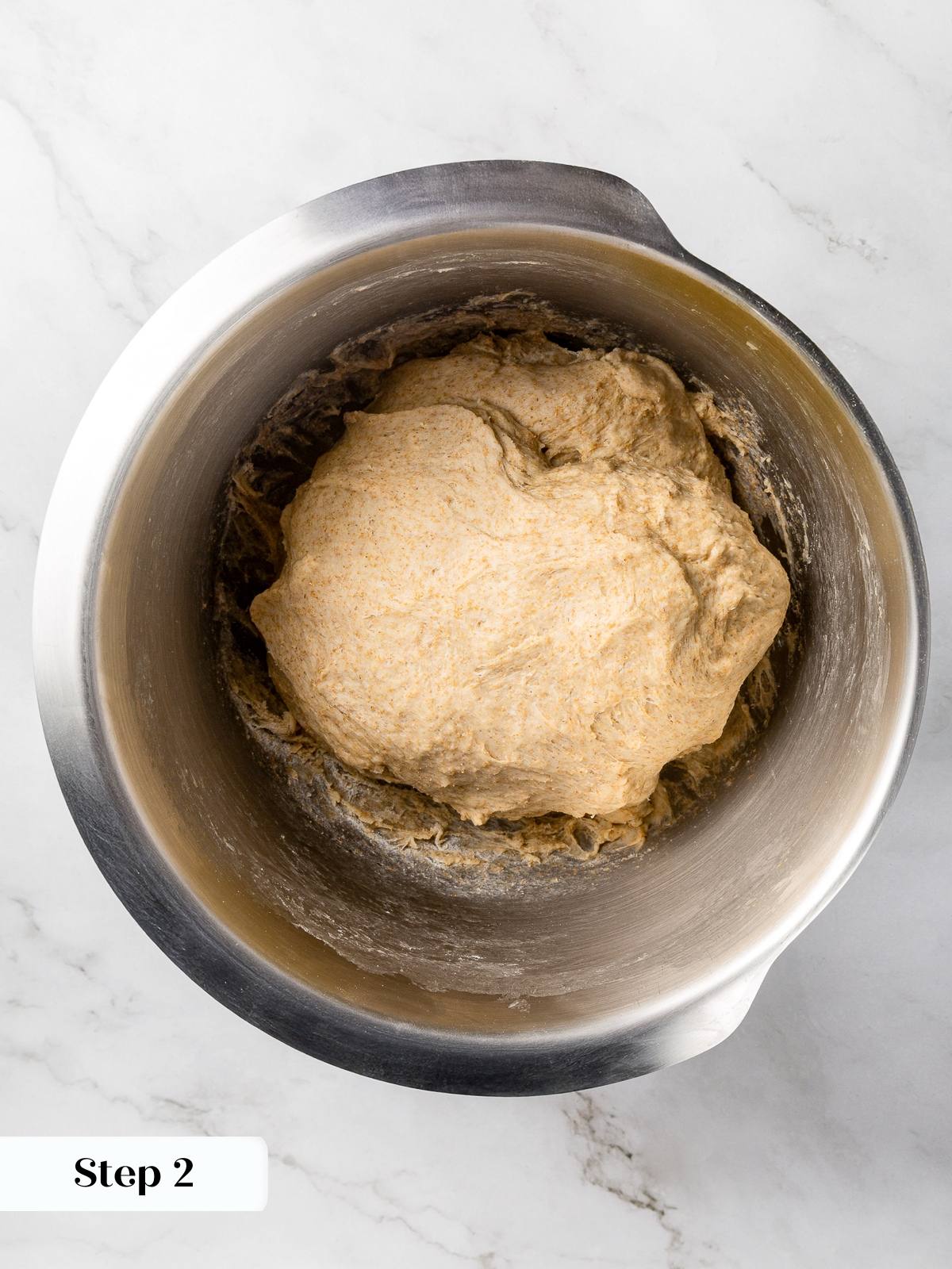 Soft focaccia dough gathered in mixing bowl before transferring to pan.