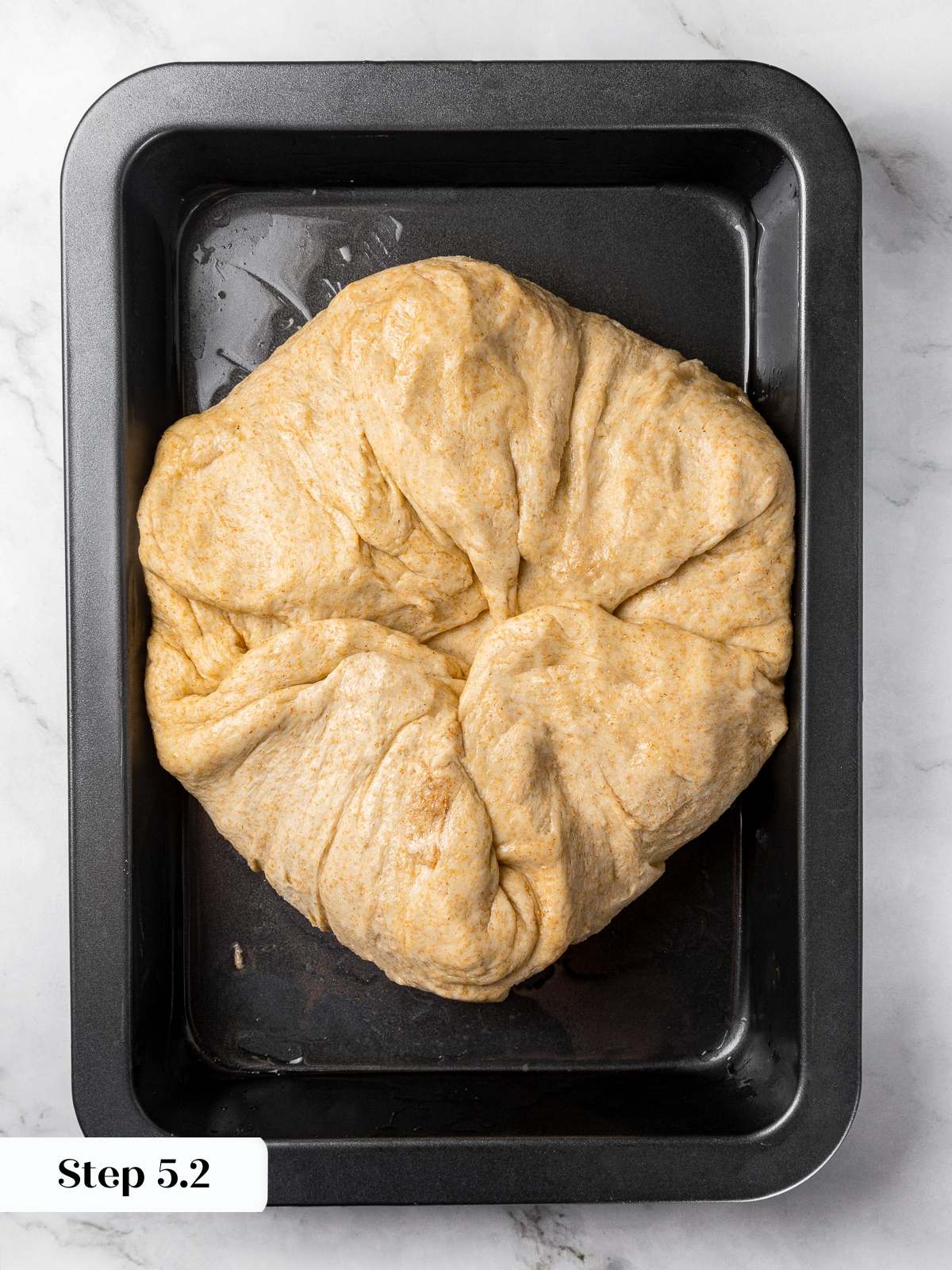 Dough corners folded inward to strengthen gluten and structure in focaccia.