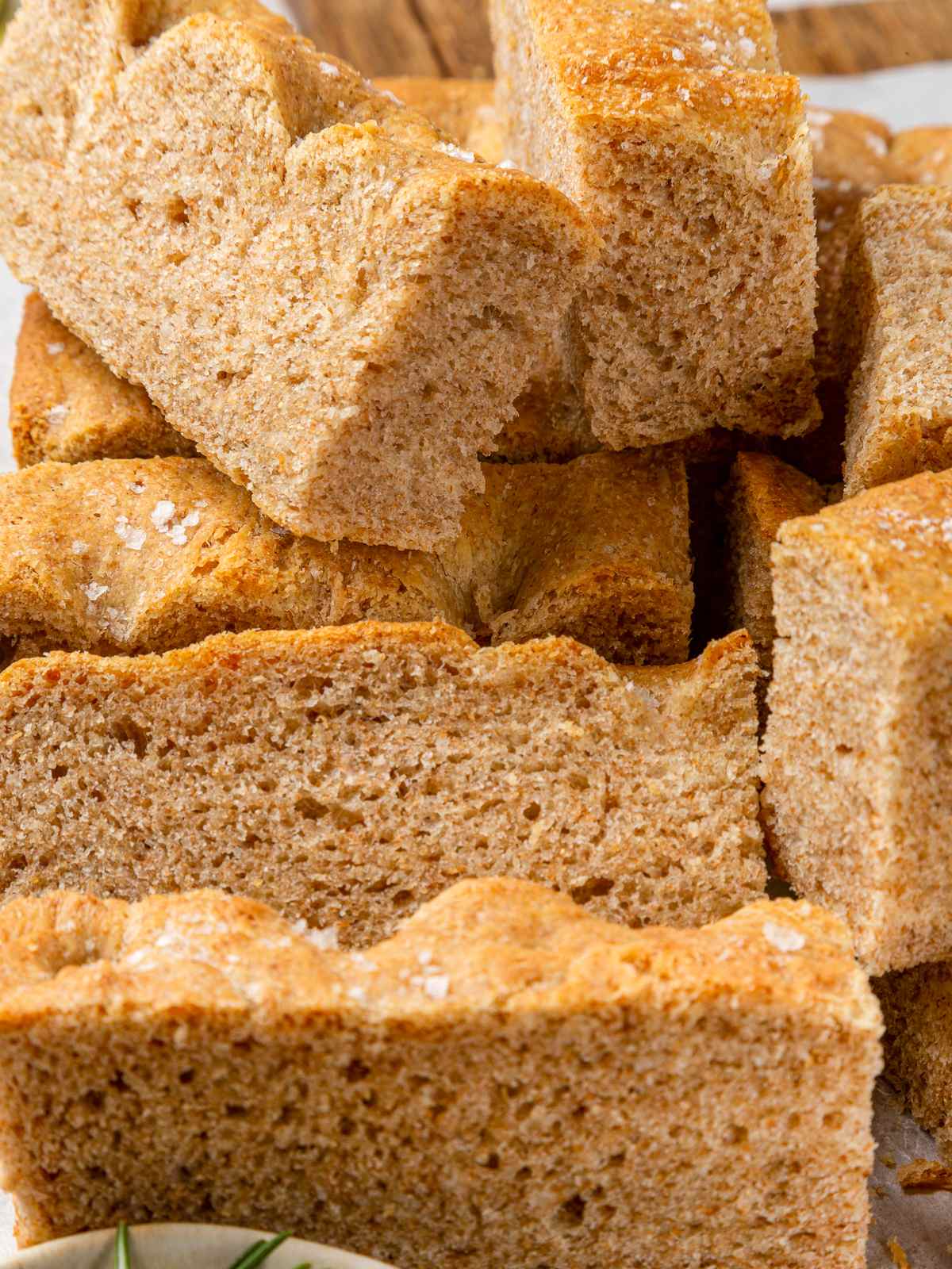 Thick slices of focaccia bread with airy crumb and crisp edges.