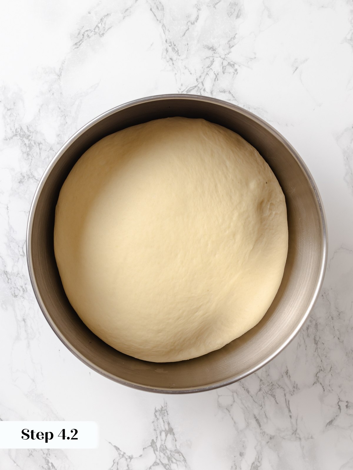 Dough after bulk proof doubled in size with airy texture and soft surface.