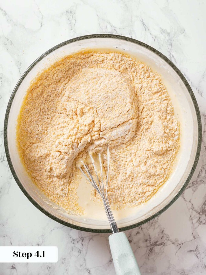 Batter being gently mixed to combine dry and wet ingredients without overmixing.