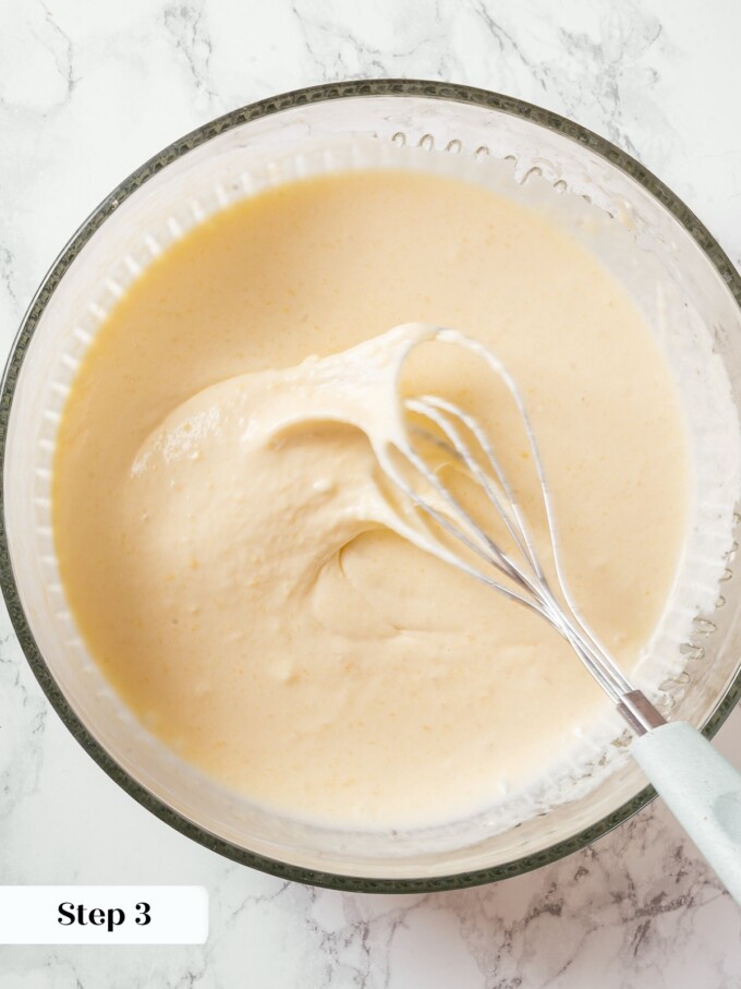 Wet ingredients whisked until smooth including eggs, sour cream, and sourdough discard.