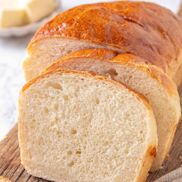 Buttermilk sandwich bread sliced and styled with butter for square format social post.