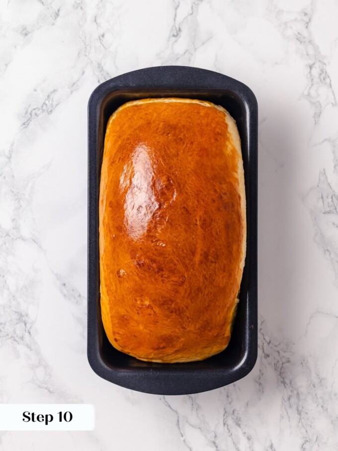 Deep golden buttermilk bread loaf finished baking inside dark nonstick loaf pan.