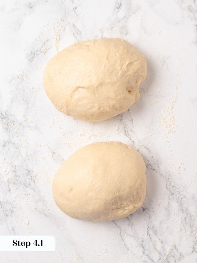 Buttermilk dough divided into two equal portions on lightly floured marble counter.