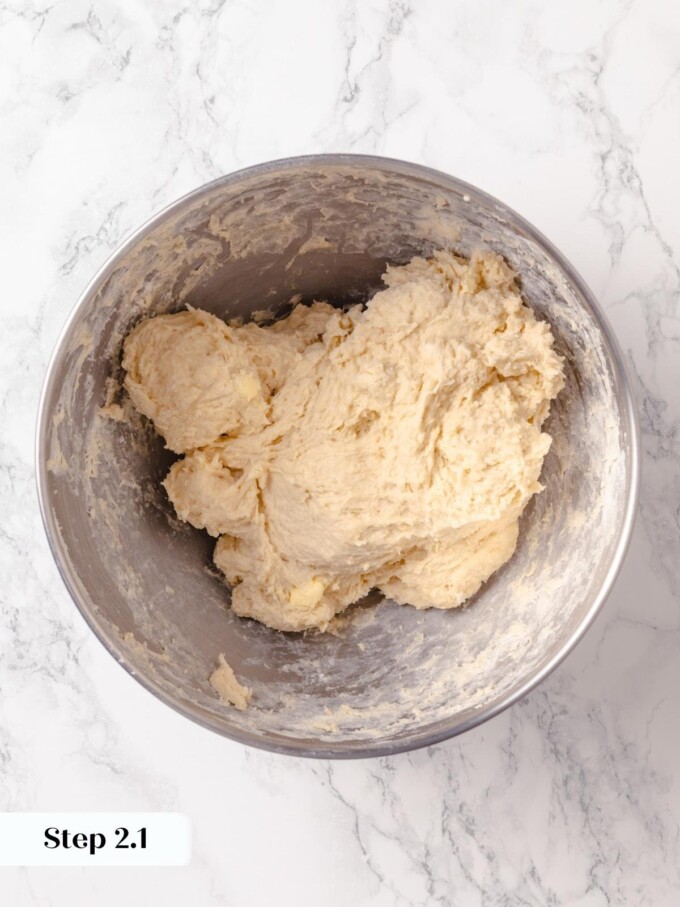 Mixed buttermilk bread dough with small butter pieces still visible after low speed combining.