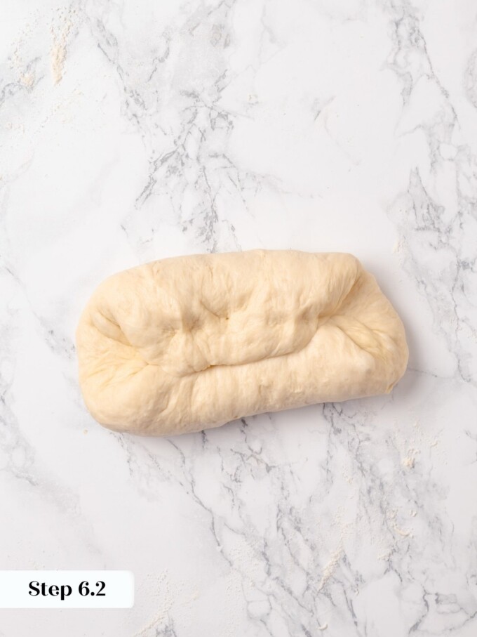 Buttermilk dough folded into a tighter rectangle after second shaping fold inward.