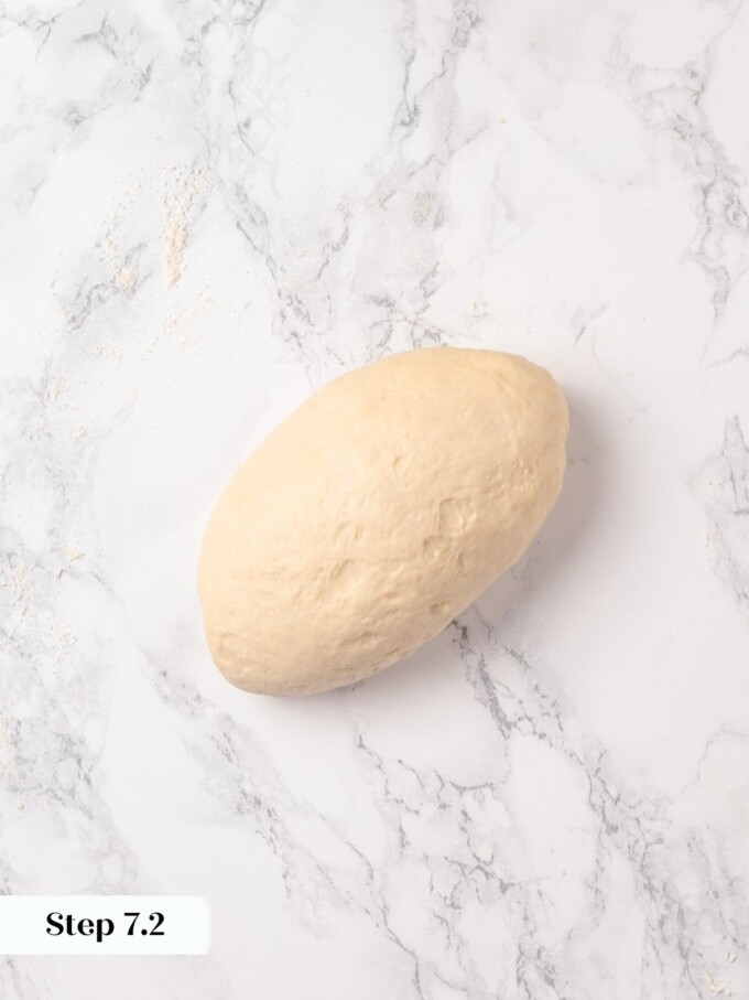 Smooth buttermilk dough log fully shaped and ready to place in loaf pan.