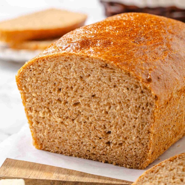 Cut end of fluffy whole wheat sandwich loaf revealing tender even crumb texture.