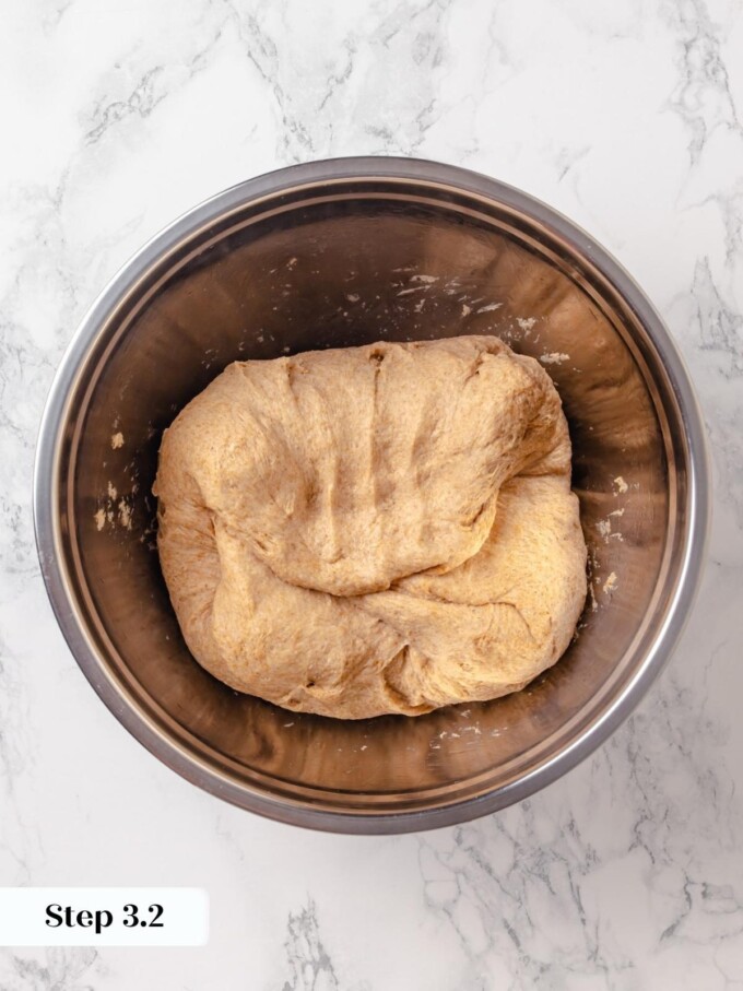 Whole wheat dough after second round of stretch and fold inside stainless bowl.