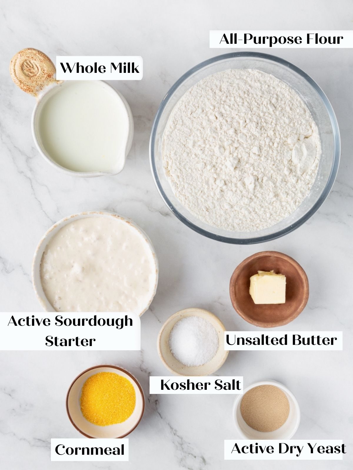 Labeled bowls of whole milk, flour, sourdough starter, butter, kosher salt, cornmeal, and active dry yeast.