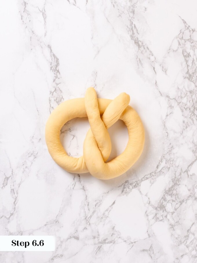 Pretzel rope folded down with twisted ends pressed across the bottom curve to form the shape.