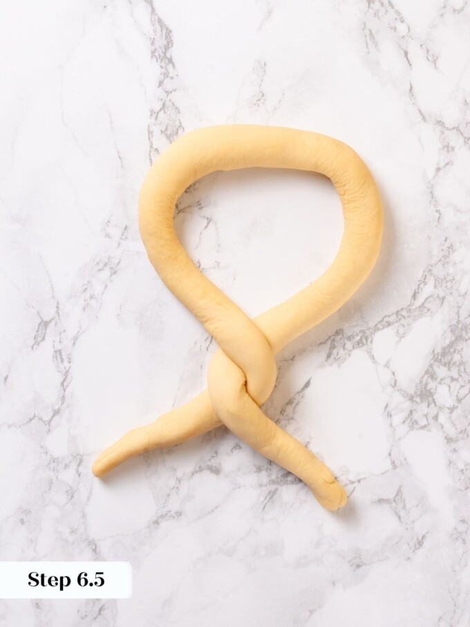 Pretzel rope ends twisted around each other one full turn during the shaping process on marble.