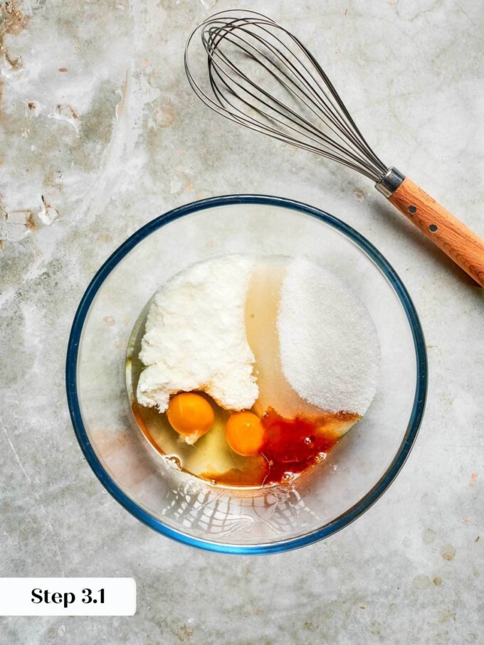 Wet ingredients combined in a glass bowl before whisking, ready to be emulsified for strawberry bread batter.