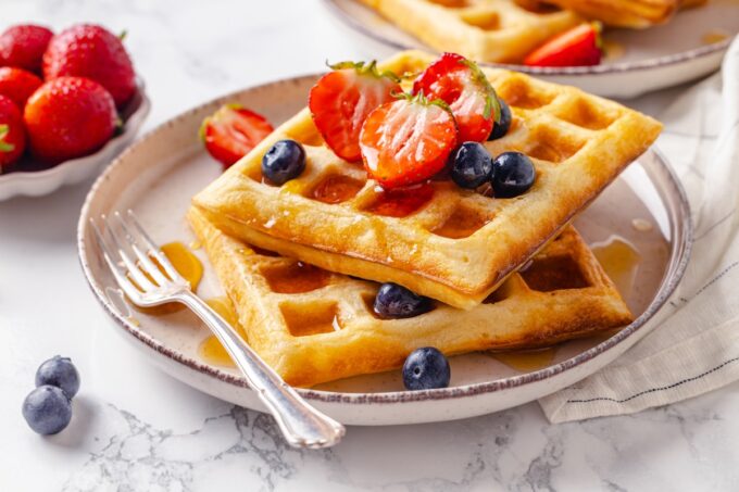 Landscape framing of belgian waffles fits wide blog layouts while showing their crisp, golden surface.