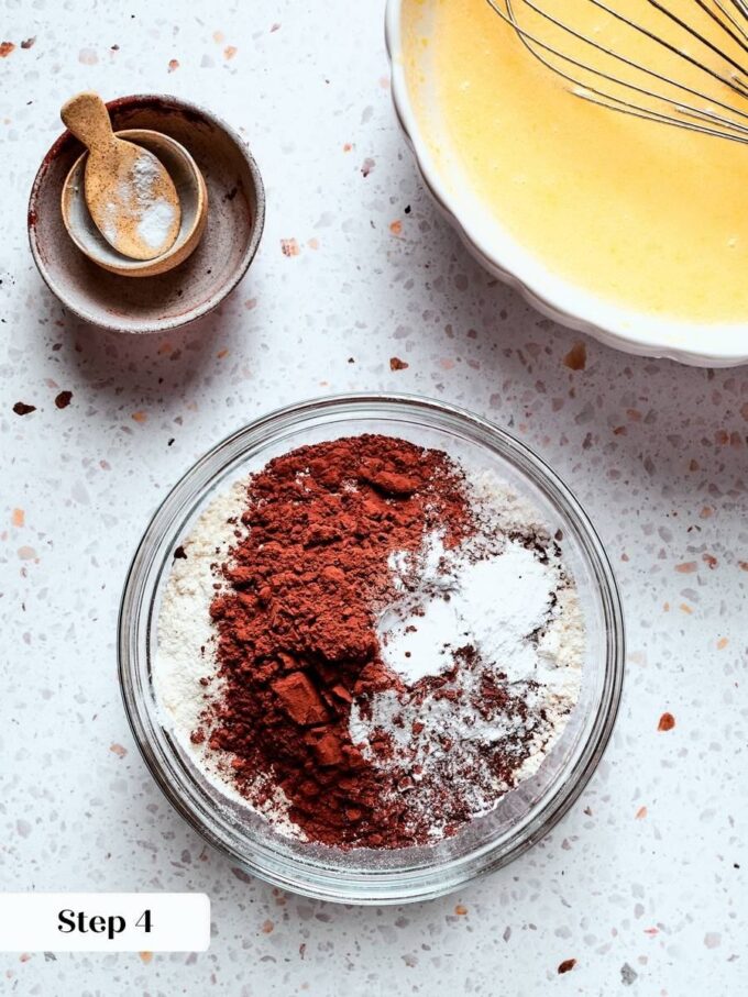 Whisking cocoa, flour, and leaveners separately distributes them evenly through the chocolate bread before combining.