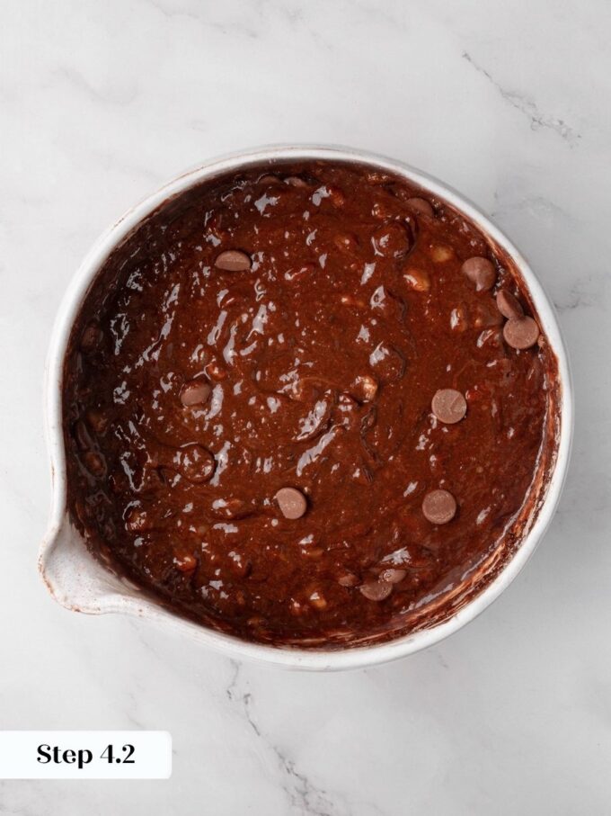 Gentle folding distributes the chips without deflating the batter for gluten free chocolate banana bread.