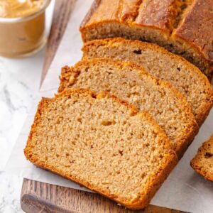 Warm golden tones and a soft crumb make this square slice of peanut butter bread inviting.