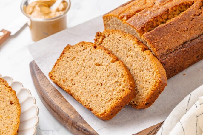 Wide framing for recipe headers shows the sliced peanut butter bread beside a creamy jar.