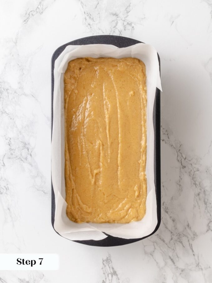 Parchment lining instead of spray keeps the edges from overbrowning while this peanut butter bread bakes.