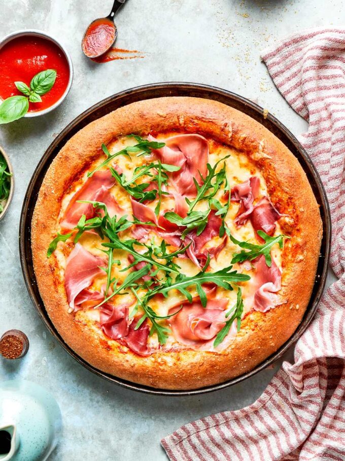 Styled from above, these whole wheat pizza dough pies look ready for a relaxed gathering.