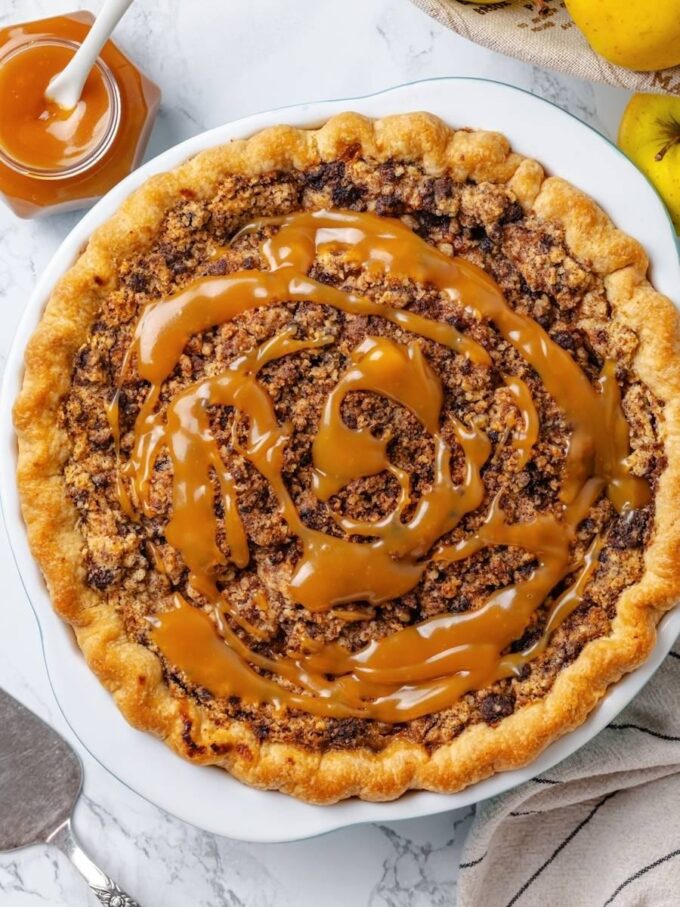 The final caramel drizzle before serving completes the double-caramel finish of this Dutch caramel apple pie.