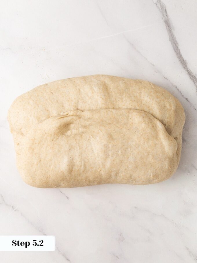Rotating a half turn and repeating the fold squares off the sourdough rye bread log.