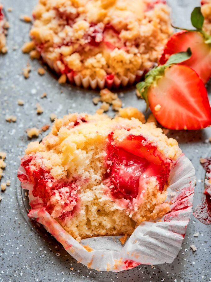 One bite reveals why this strawberry muffin recipe stays moist, with fruit tucked beneath the crumble.