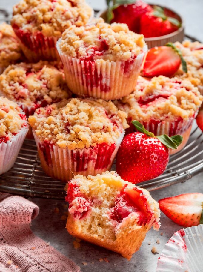 The stack plus an inside view shows the crumb and fruit of this strawberry muffin recipe.