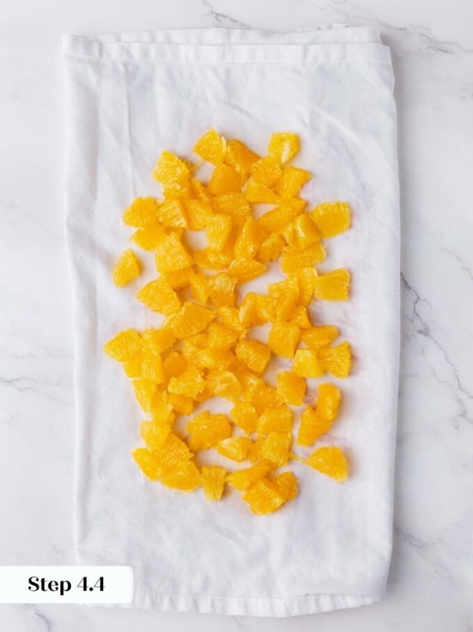 Patting the fruit dry prevents the wet tunnels that would otherwise ruin this orange bread.