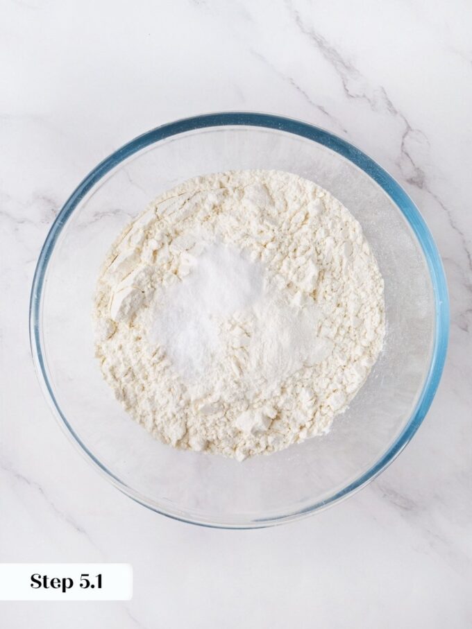 Combining the leaveners with flour first ensures they disperse evenly through the orange bread crumb.