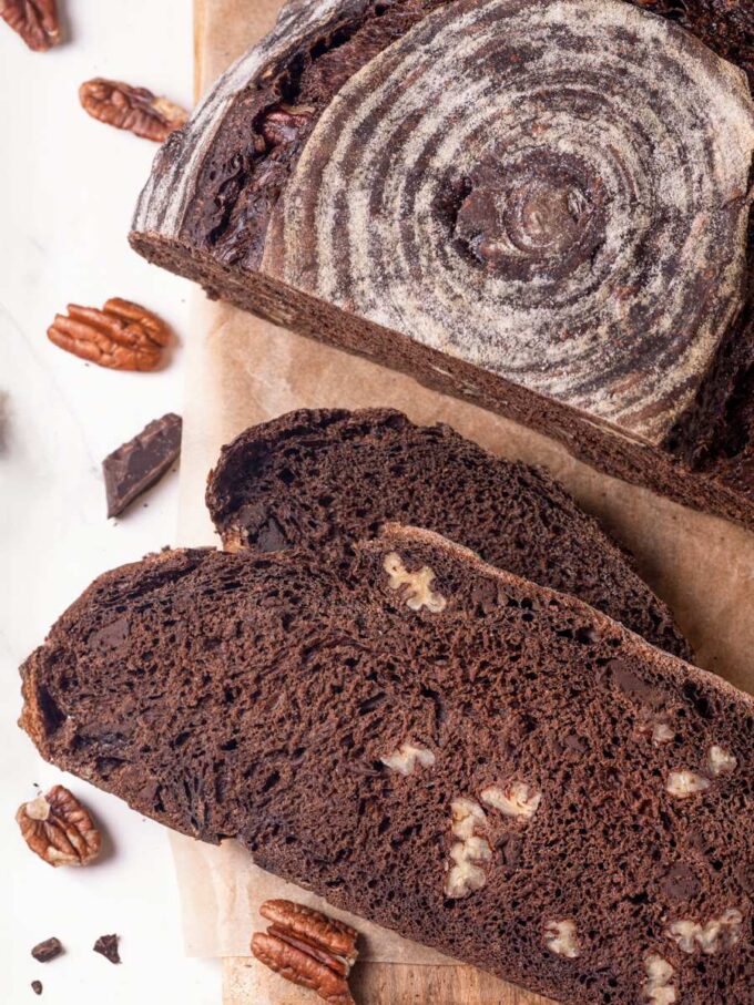 Two slices laid flat make the open chewy crumb of chocolate sourdough bread the main attraction.