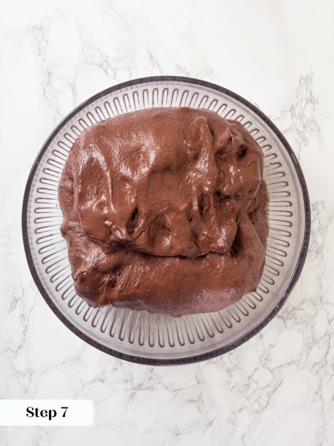 Pre-shaping on a floured surface begins building the tension that produces chocolate sourdough bread's tall rise.