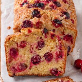 Sugar crystals still visible along each top edge signal the crunch in this cranberry bread.