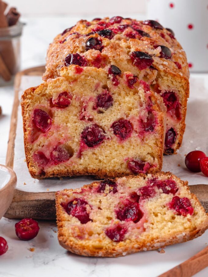 Warm cinnamon props echo the spice running quietly through every slice of this cranberry bread.