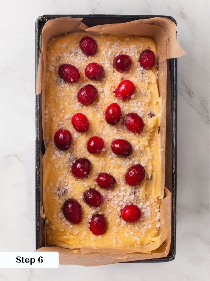 White sanding sugar goes on before baking because it fuses into the cranberry bread crust.