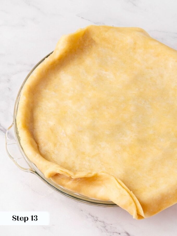 Laying on the top crust seals in the pre-cooked homemade apple pie filling.