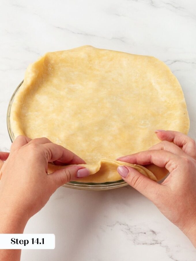 Rolling the edge under anchors homemade apple pie crust so it never slumps while baking.