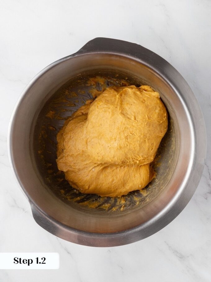 A full cup of puree turns pumpkin cinnamon rolls dough this color, sticky by design.