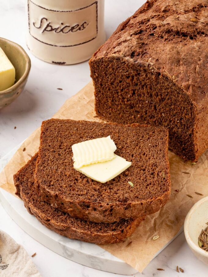Salted butter melting into a thick slice is the simplest way to enjoy Russian black bread.
