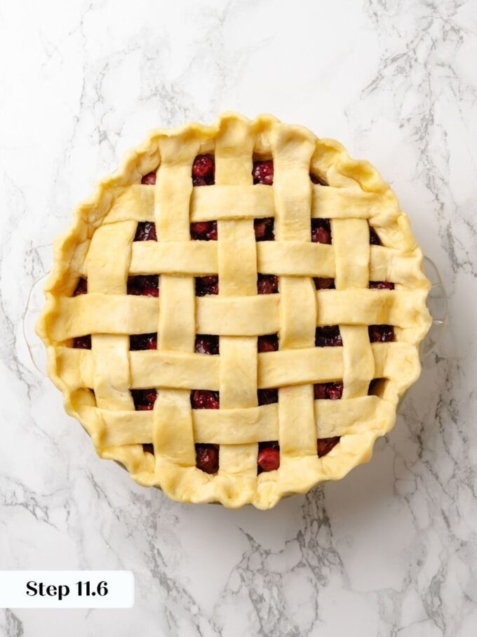 Crimped edges seal both crusts so the sour cherry pie bakes with a defined rim.