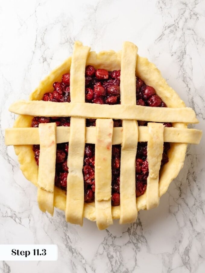 Each new cross strip tightens the weave, giving the sour cherry pie its classic lattice pattern.