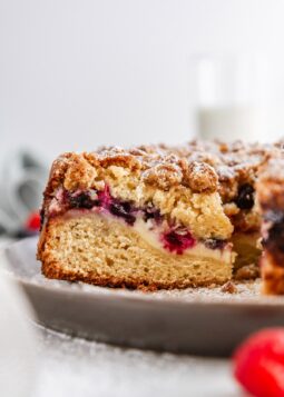a close-up shot of a slice of berry cream cheese coffee cake